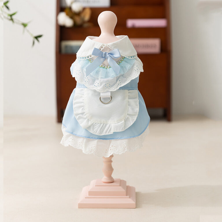 Small dog wearing maid-style pet lace dress with leash attachment
